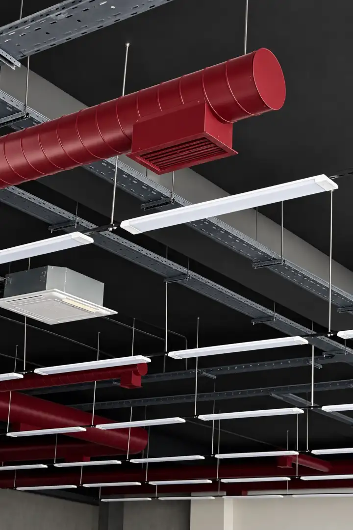 A burgundy duct with a supply grille under a ceiling slab